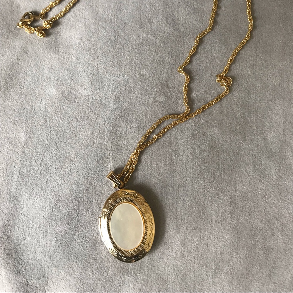 Golden tone locket.